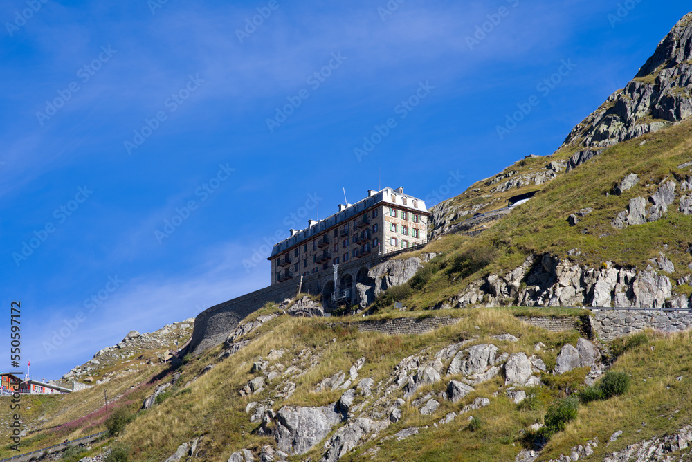 Scenic view of famous Swiss mountain pass Furkapass with serpentine road and Bélvedère Hotel on a sunny late summer day. Photo taken September 12th, 2022, Furka Pass, Switzerland. Scenic view of famous Swiss mountain pass Furkapass with serpentine road and Bélvedère Hotel on a sunny late summer day. Photo taken September 12th, 2022, Furka Pass, Switzerland.