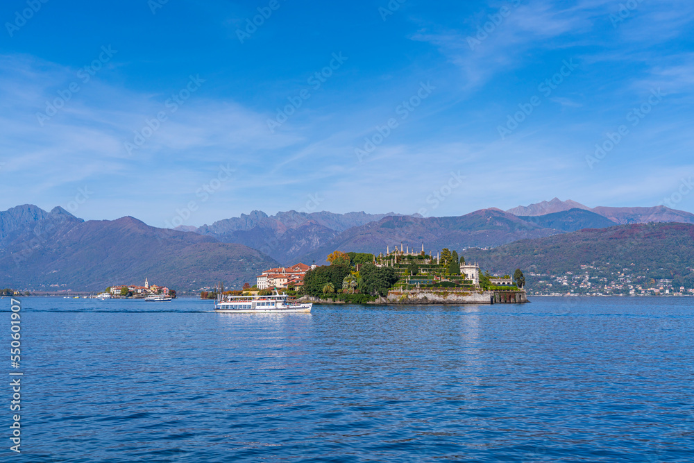 Lake Maggiore at Stresa, view over the lake to Isola Bella - island Bella with a ferry, background the alps in Italy