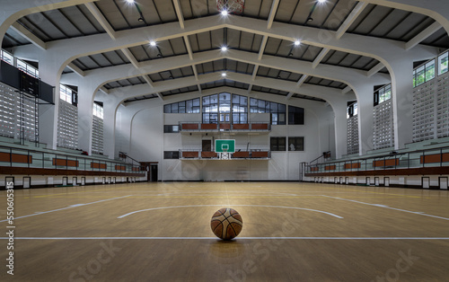 Obraz na płótnie Basketball ball placed on court floor in the basketball gym. View from Empty basketball gym, Space for text, Selective focus. w salonie