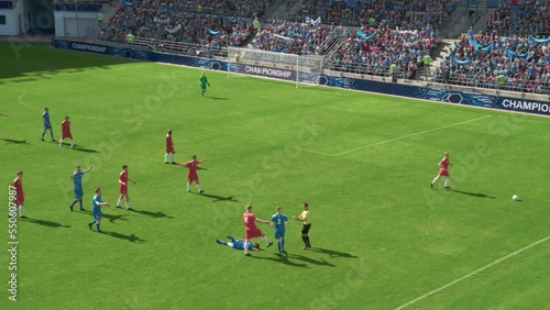 Professional Soccer Football Match Championship on Stadium: Blue Team Players Attacks, Loses Ball to Foul. Action Game on a Tournament. Slow Motion Athlete In Pain Lying on the Grass after The Fall
