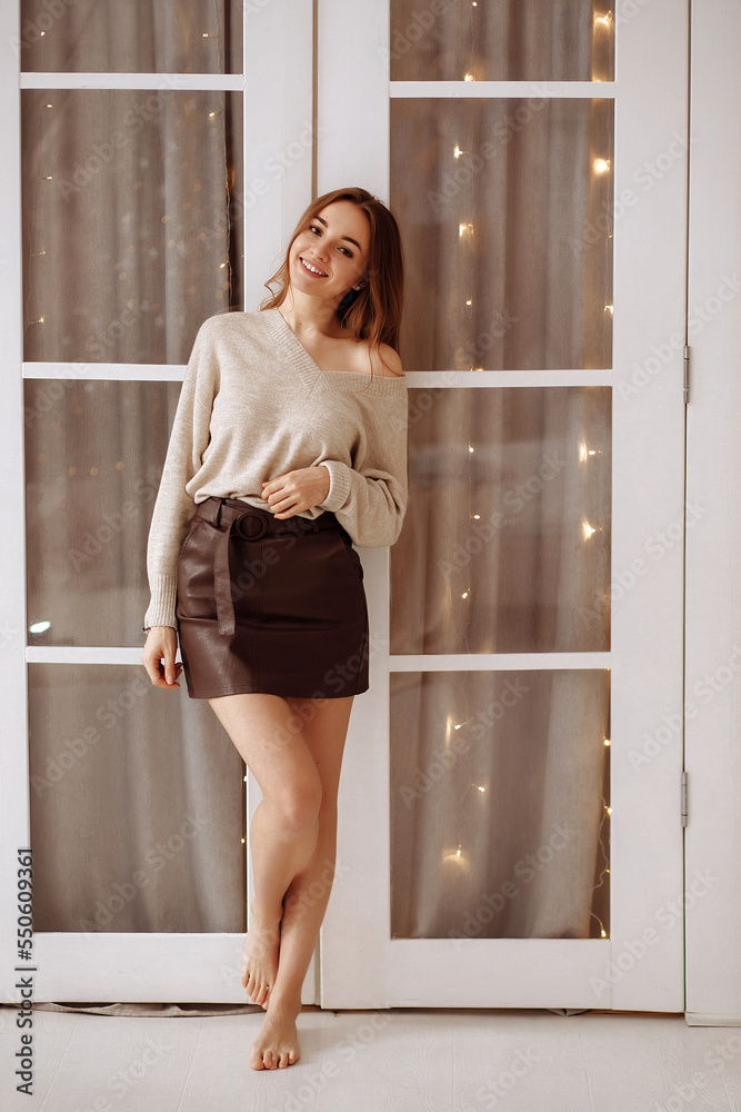 Fototapeta premium Young woman on the background of the Christmas interior.