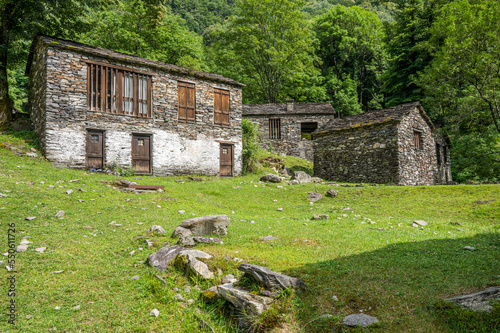 Ruined stone houses and mills in an abandoned mountain village in the Alps