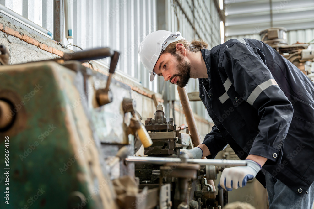 Team of engineers practicing maintenance Taking care and practicing maintenance of old machines in the factory so that they can be used continuously.