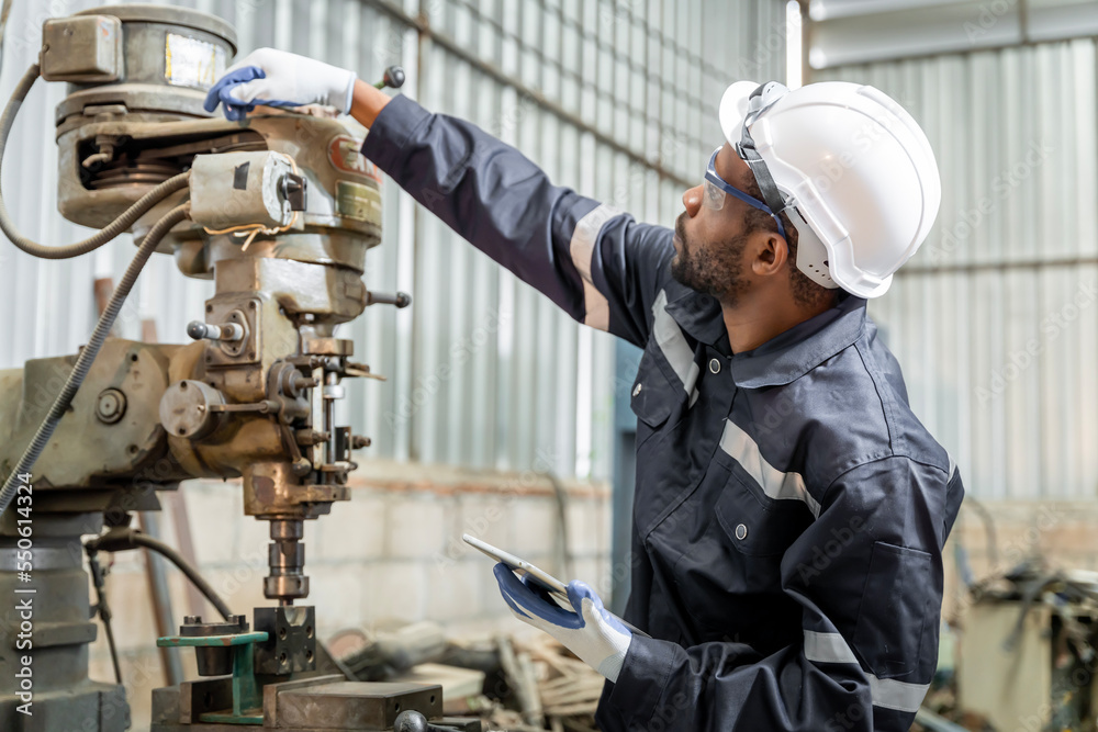 Team of engineers practicing maintenance Taking care and practicing maintenance of old machines in the factory so that they can be used continuously.