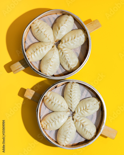 Steamed chinese dumplings closeup on yellow background
