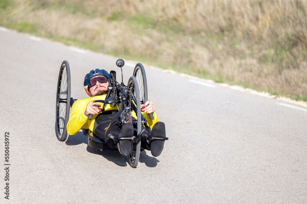 Athlete with disability training with His Handbike on a Track. High quality photography.