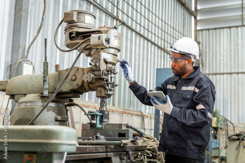 Team of engineers practicing maintenance Taking care and practicing maintenance of old machines in the factory so that they can be used continuously.