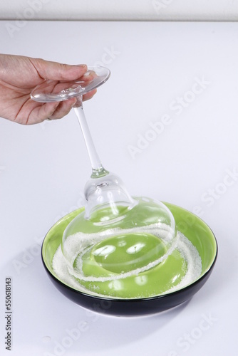 Salt being placed on cocktail glass
