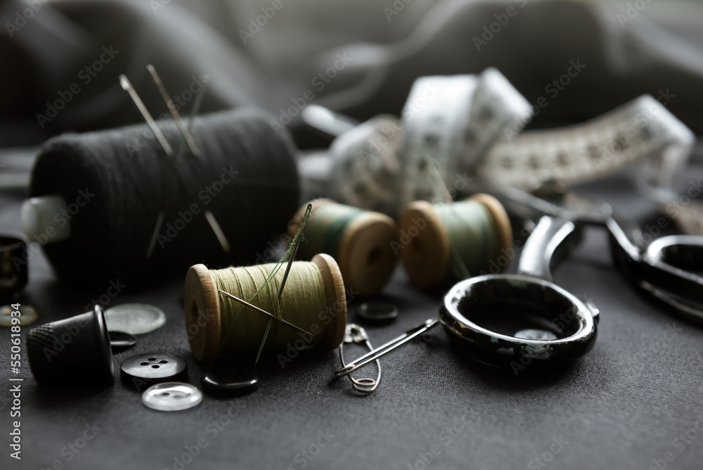 Retro tools for cutting and sewing. Needle with thread, thimble, sewing machine and scissors Retro tools for cutting and sewing. Needle with thread, thimble, sewing machine and scissors