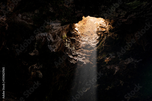 Sunray shining in stony cave