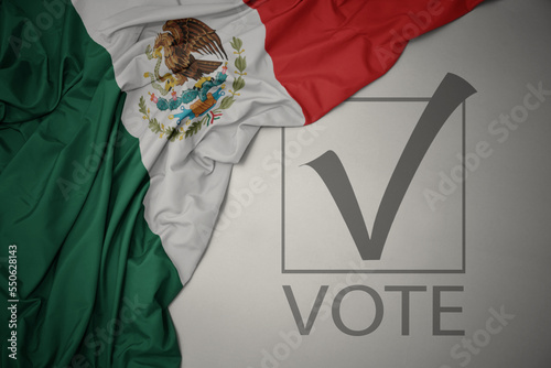 waving colorful national flag of mexico on a gray background with text vote. 3D illustration