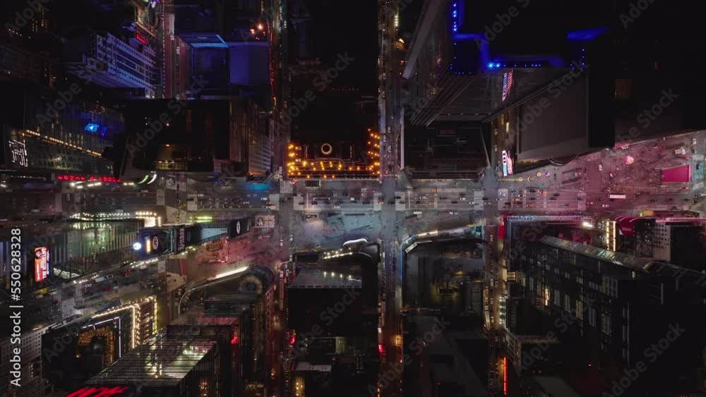 Aerial birds eye overhead top down view of colourful Times Square. Reflection of colours from advertisement displays. City at night from height. Manhattan, New York City, USA