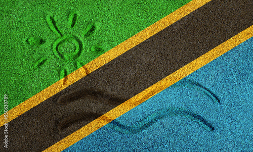 Flag of Tanzania on the sand. Sun and sea waves painted on the sand. Vacation concept in the resorts of the Tanzania and Zanzibar.