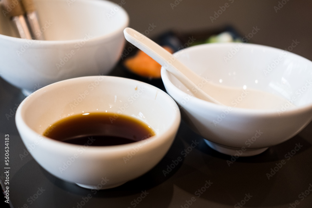 Ponzu vinegar sauce in a white bowl. Close up Ponzu vinegar sauce in a white bowl. Close up