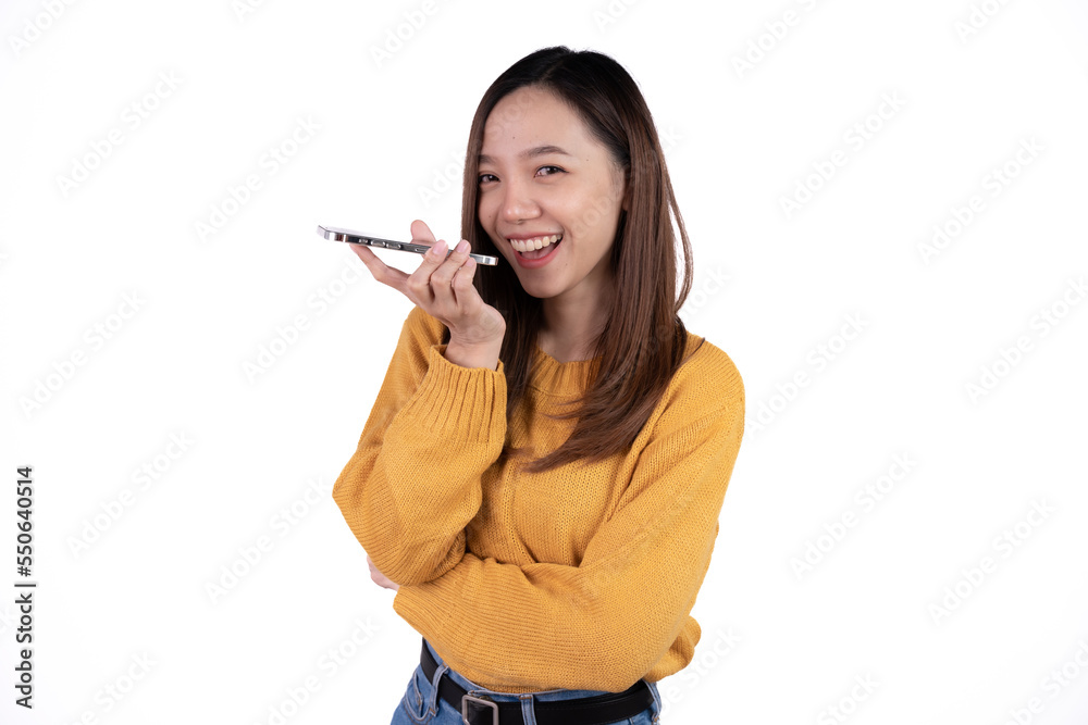 Portrait of a smiling casual asian woman holding smartphone over white background. Portrait of a smiling casual asian woman holding smartphone over white background.