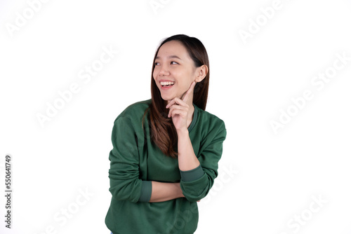 Young asian woman with yellow sweater over isolated white background pointing finger to the side.