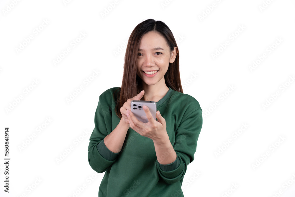 Portrait of a smiling casual asian woman holding smartphone over white background. Portrait of a smiling casual asian woman holding smartphone over white background.