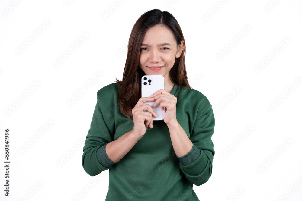 Portrait of a smiling casual asian woman holding smartphone over white background. Portrait of a smiling casual asian woman holding smartphone over white background.