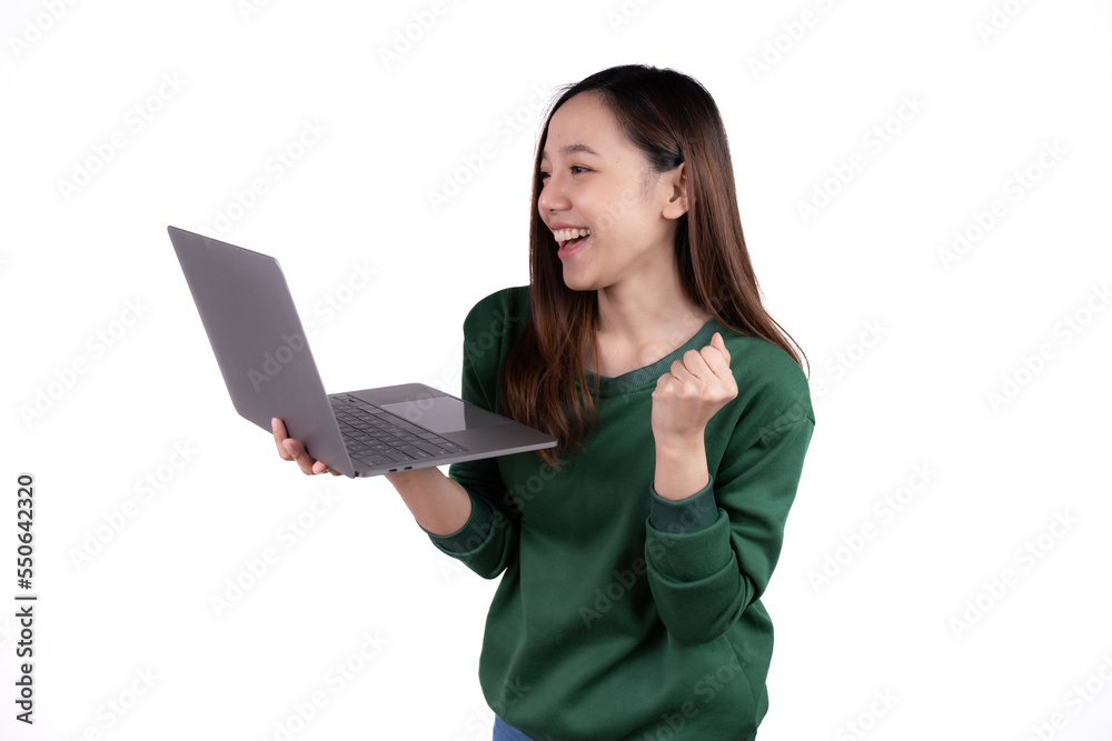 Portrait of an excited young asian girl holding laptop computer and celebrating success isolated over white background. Portrait of an excited young asian girl holding laptop computer and celebrating success isolated over white background.
