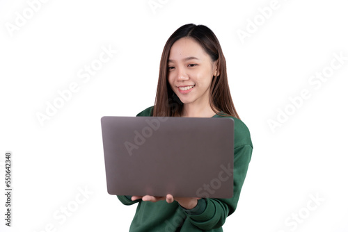 Portrait of an excited young asian girl holding laptop computer and celebrating success isolated over white background.