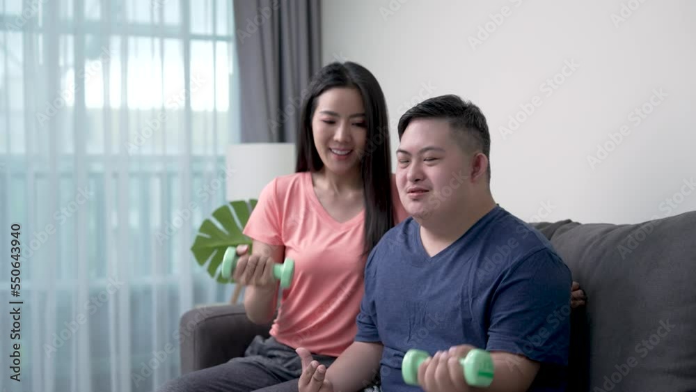 Asian mother and son exercising together at home. Asian mother and son exercising together at home.