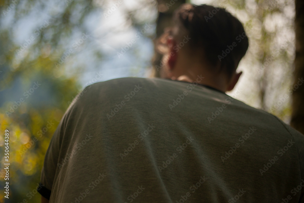 Back guy. Man in park. Close-up jacket. Man in back. Back guy. Man in park. Close-up jacket. Man in back.