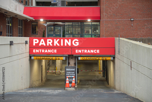 Front view of the enter and exit in a parking lot on the street.
