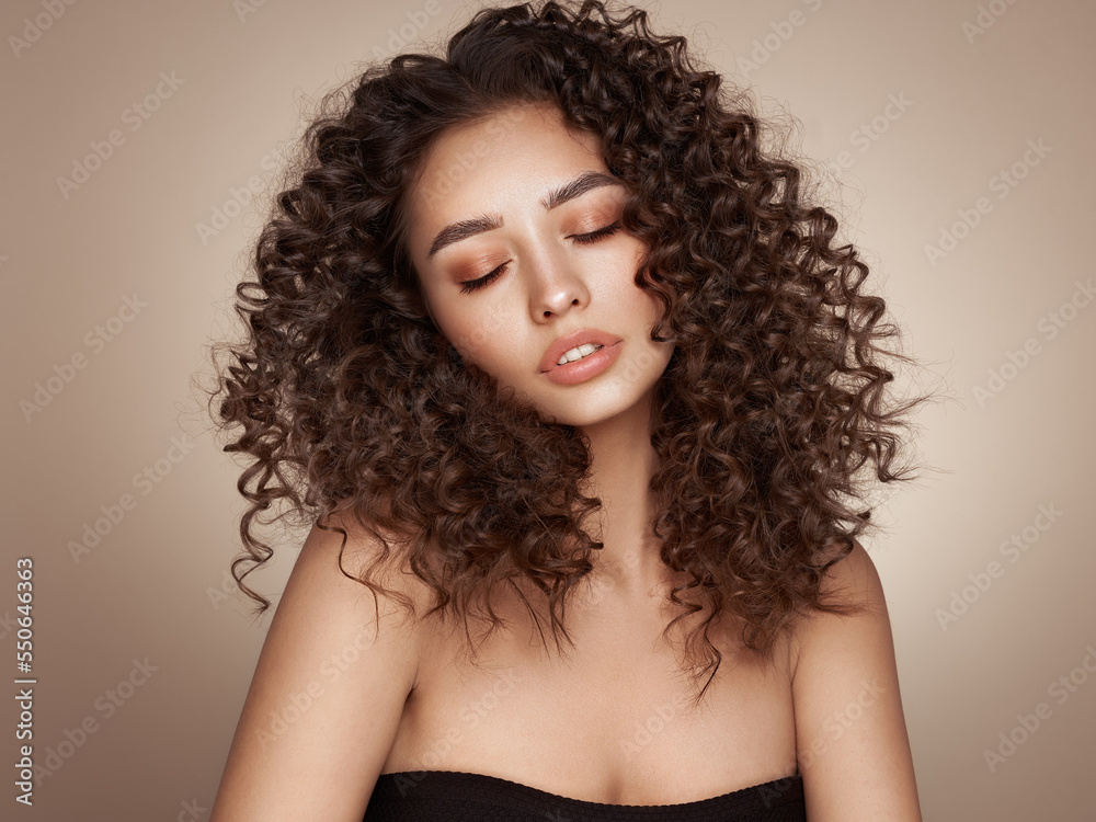 Fashion studio portrait of beautiful smiling woman with afro curly hairstyle. Fashion and beauty Fashion studio portrait of beautiful smiling woman with afro curly hairstyle. Fashion and beauty