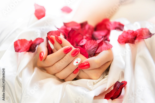 red nails with rose petals photo