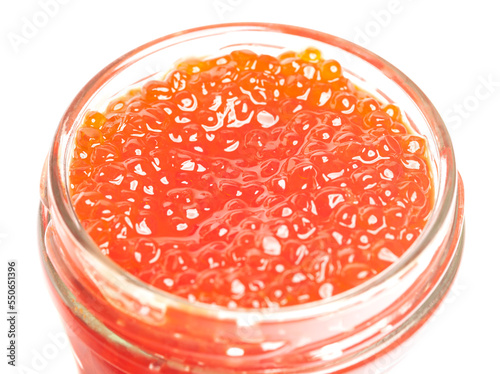 Glass jar with delicious red caviar isolated on white background.