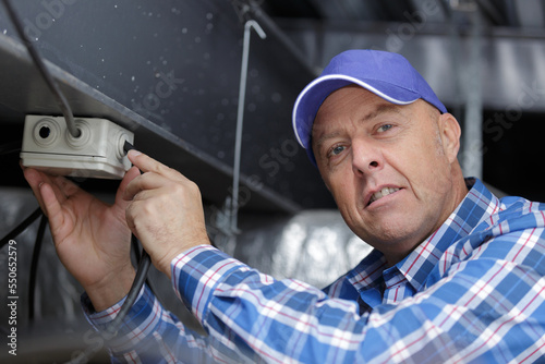 a mature engineer working with cables