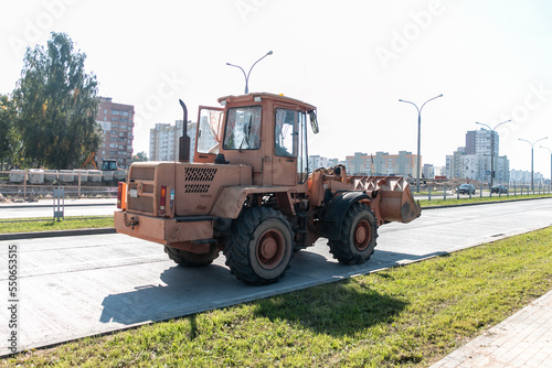 Obraz na płótnie A wheeled bulldozer is conducting road construction work in the city. w salonie