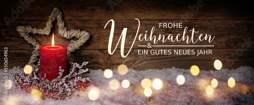 Christmas Greeting Card with German text Frohe Weihnachten und ein gutes neues Jahr. Merry Christmas and Happy New Year. Panorama, Banner. Christmas candle in winter snow landscape.