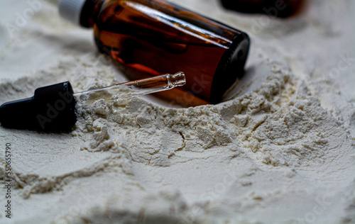 Obraz na płótnie Natural cosmetics face oil in brown bottle on the sand w salonie