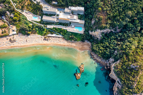 Agios Gordios exotic beach in Corfu island Greece. Agios Gordios beach  Corfu island  Greece. Panoramic view of the Agios Gordios beach  sandy seashore with beach umbrellas and deck chairs.