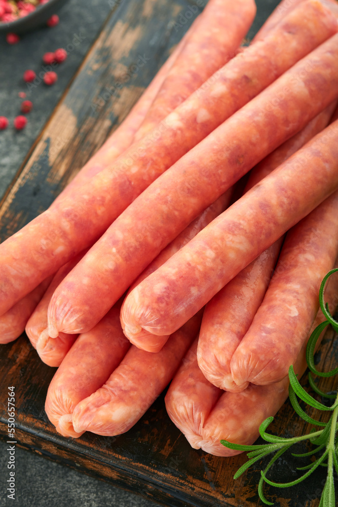 Meat beef sausages. Raw barbecue sausages with spices, vegetables and ingredients for cooking on black background. Top view. Copy space. Oktoberfest menu concept. Meat beef sausages. Raw barbecue sausages with spices, vegetables and ingredients for cooking on black background. Top view. Copy space. Oktoberfest menu concept.