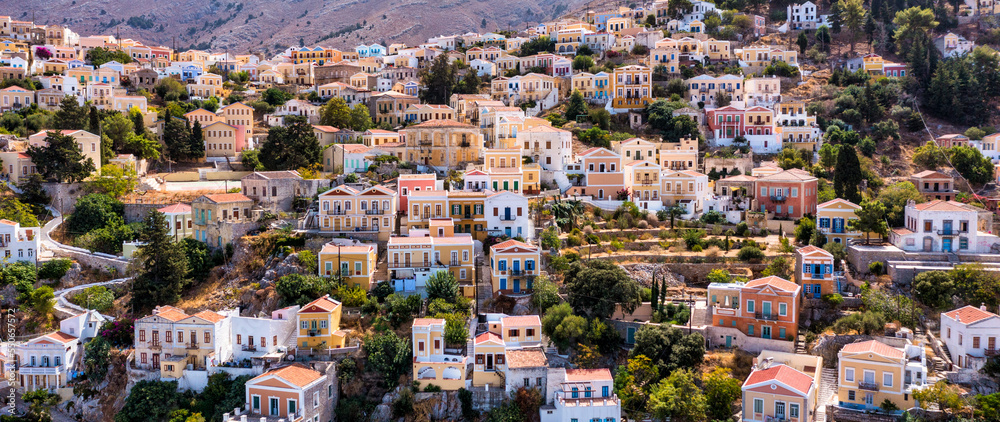 Aerial view of the beautiful greek island of Symi (Simi) with colourful houses and small boats. Greece, Symi island, view of the town of Symi (near Rhodes), Dodecanese.