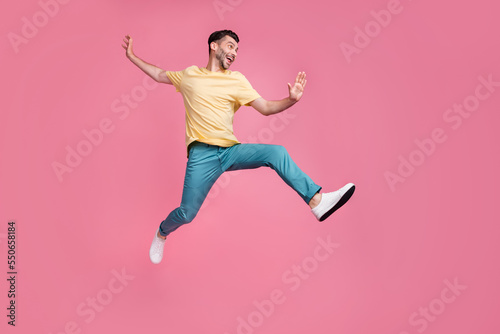 Full length photo of crazy optimistic man sportsman participate sport contest champion look empty space isolated on pink color background