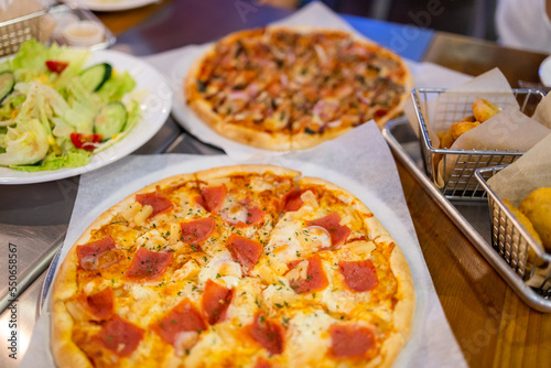  Pizza on plate on wood table with ingredients