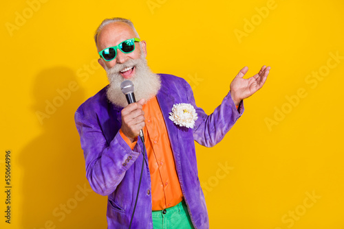 Photo of famous popular mc singer retired pensioner stylish bright costume celebrate event empty space isolated on yellow color background