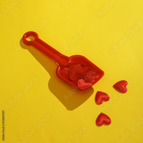 sandbox paddle with hearts on a yellow background. Valentine's day, love concept