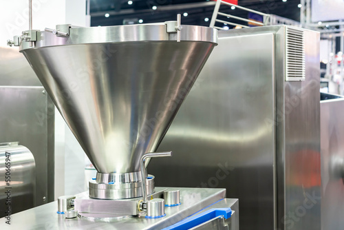 stainless hopper or chute component of food manufacturing for input contain and hold material of filling machine in industrial photo
