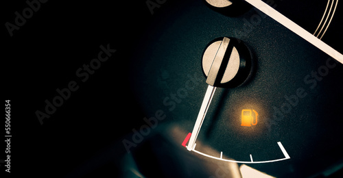Foto Low fuel indicator light on car dashboard, panoramic banner with copy space on b