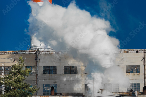 Emission of caustic toxic steam smoke at the plant industry and pollution of the environment, air and atmosphere, environmental problems