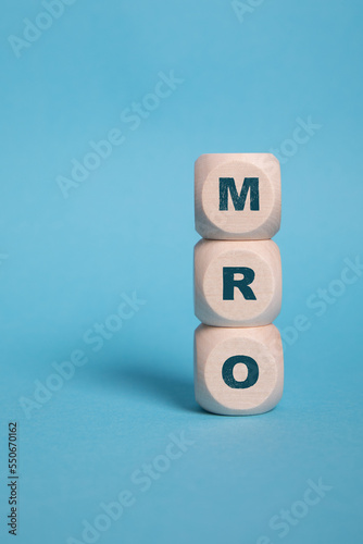 MRO, Maintenance Repair and Overhaul acronym letters on wooden blocks isolated on light Blue background copy space