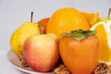 Fruits of orange and yellow colors - apples, persimmons, pears and oranges.