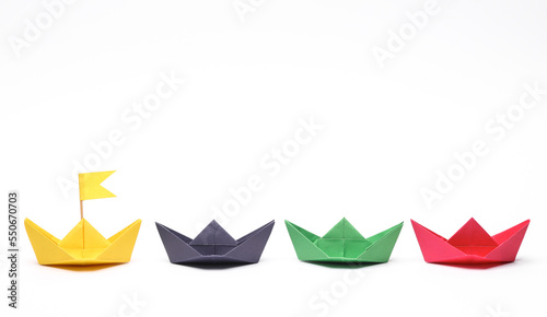 Paper colored boats on white background. Business, leadership concept