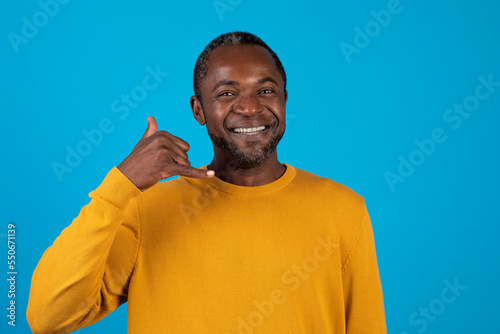 Handsome african american man showing a call me sign