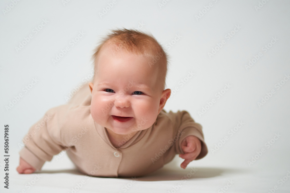 Portrait of an infant learning to crawl on a white background Portrait of an infant learning to crawl on a white background