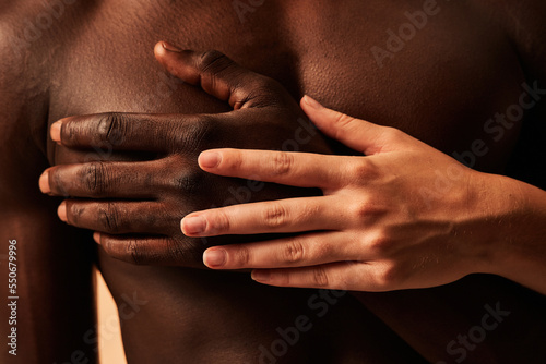 Crop couple touching hands in studio